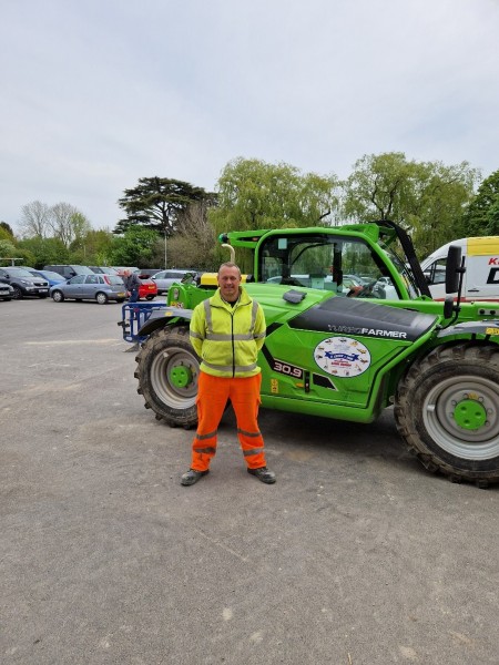 Kevin Turner in front of some machinery