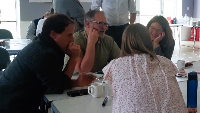 Group of people chatting at a workshop