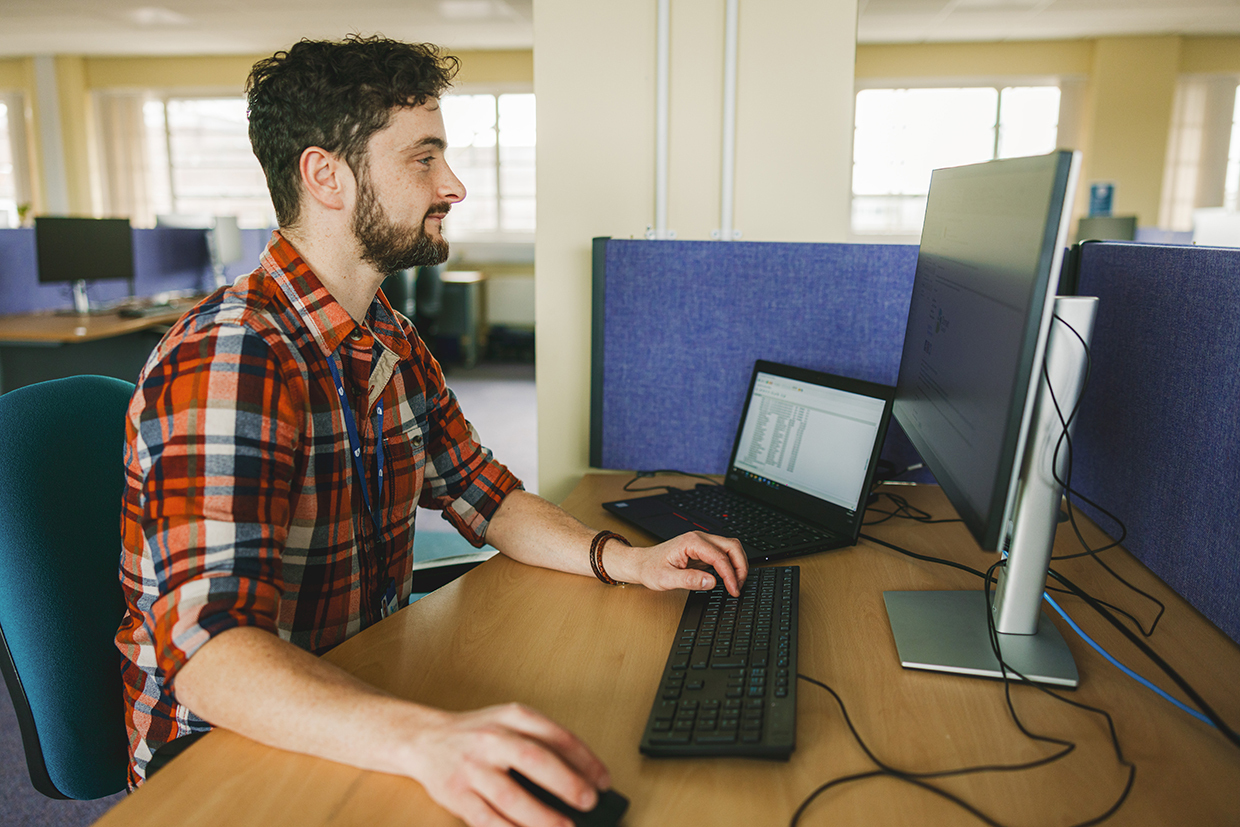 Two people sitting and chatting in an office.